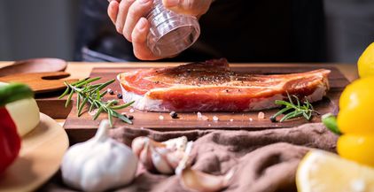 chef-prepares-pork-chop-steak-with-barbecue-sauce-2021-10-06-09-52-48-utc