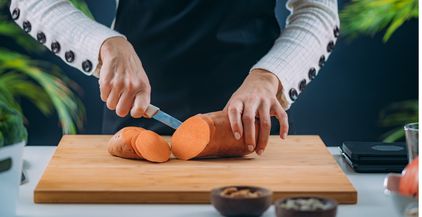 cutting-fresh-organic-sweet-potato-2021-08-27-18-15-55-utc