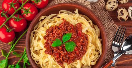 pasta-with-meat-tomato-sauce-and-vegetables-on-th-2021-12-21-19-14-36-utc