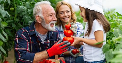 grandfather-growing-organic-vegetables-with-family-2022-07-01-16-35-33-utc