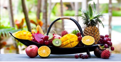 tropical-fruits-assortment-in-wooden-boat-outdoor-2021-08-26-16-29-54-utc