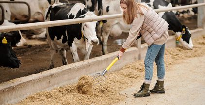 contemporary-female-worker-of-animal-farm-putting-2021-09-24-03-27-49-utc (1)