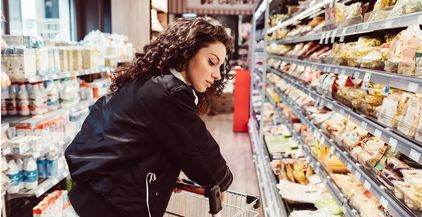 woman-pushing-shopping-cart-at-supermarket-2022-02-03-15-56-39-utc