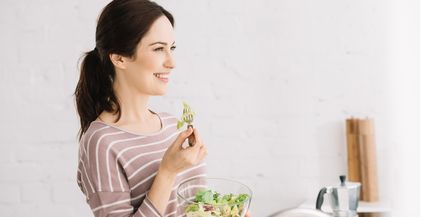 young-cheerful-woman-looking-away-while-eating-ve-2021-09-03-01-46-54-utc
