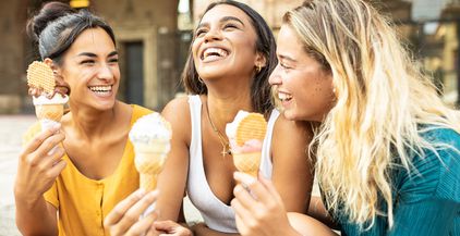 three-cheerful-multiracial-women-eating-ice-cream-2022-03-16-22-14-58-utc