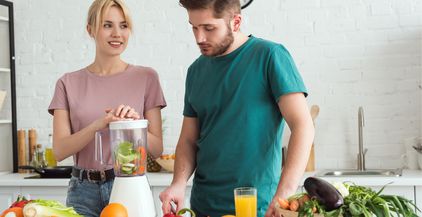 couple-of-vegans-preparing-vegetable-juice-with-ju-2021-09-03-05-16-59-utc