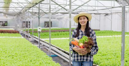 asian-woman-farmer-holding-a-basket-of-vegetables-2021-09-02-14-56-26-utc