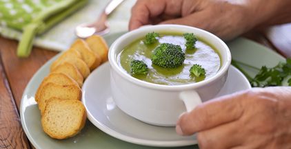 broccoli-woman-s-hands-holding-a-green-cream-soup-2021-09-03-02-27-18-utc