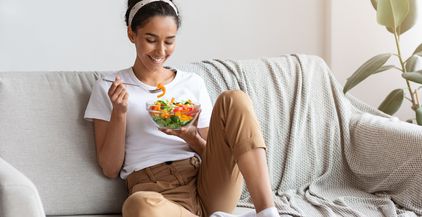 young-and-beautiful-lady-sitting-on-couch-eating-2021-09-01-15-41-27-utc