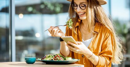 woman-eating-salad-on-a-cafe-terrace-2022-01-18-23-53-19-utc