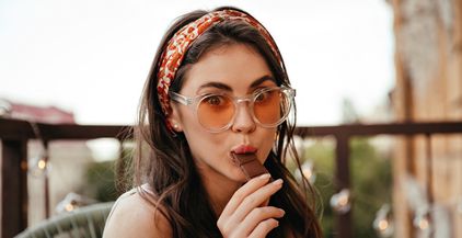 surprised-lady-in-sunglasses-eats-milk-chocolate-a-2021-09-02-23-52-28-utc