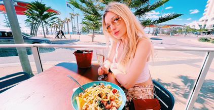 beautiful-blonde-girl-eating-seafood-pasta-at-the-2022-01-23-18-47-38-utc