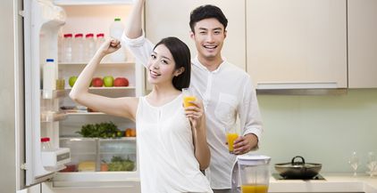 young-couple-cheering-with-orange-juice-2022-04-01-20-22-34-utc