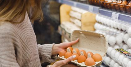 woman-chooses-chicken-eggs-in-a-farm-food-store-f-2022-04-07-20-09-11-utc