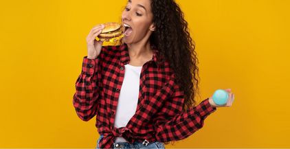 funny-hungry-lady-holding-burger-and-dumbbell-2022-02-03-02-02-56-utc