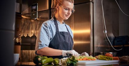 european-beautiful-female-chef-in-a-dark-restauran-2022-02-02-03-58-53-utc