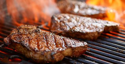 grilling-steaks-on-flaming-grill-and-shot-with-sel-2022-03-26-11-58-49-utc