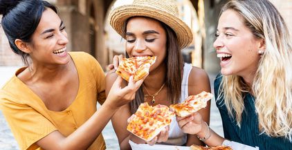 three-cheerful-multiracial-women-eating-pizza-in-t-2022-02-02-18-32-59-utc (1)