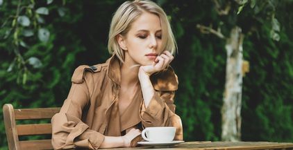 beautiful-woman-in-coat-with-cup-of-coffee-at-wood-2022-01-07-19-33-30-utc