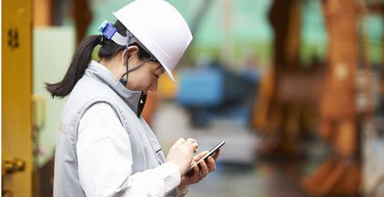 worker-using-smartphone-at-shipyard-goseong-gun-2022-03-08-00-14-34-utc