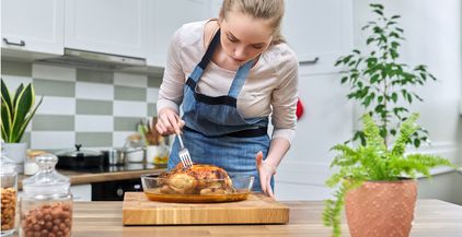 woman-cooking-baked-chicken-at-home-in-the-kitchen-2022-01-27-16-35-54-utc (1)